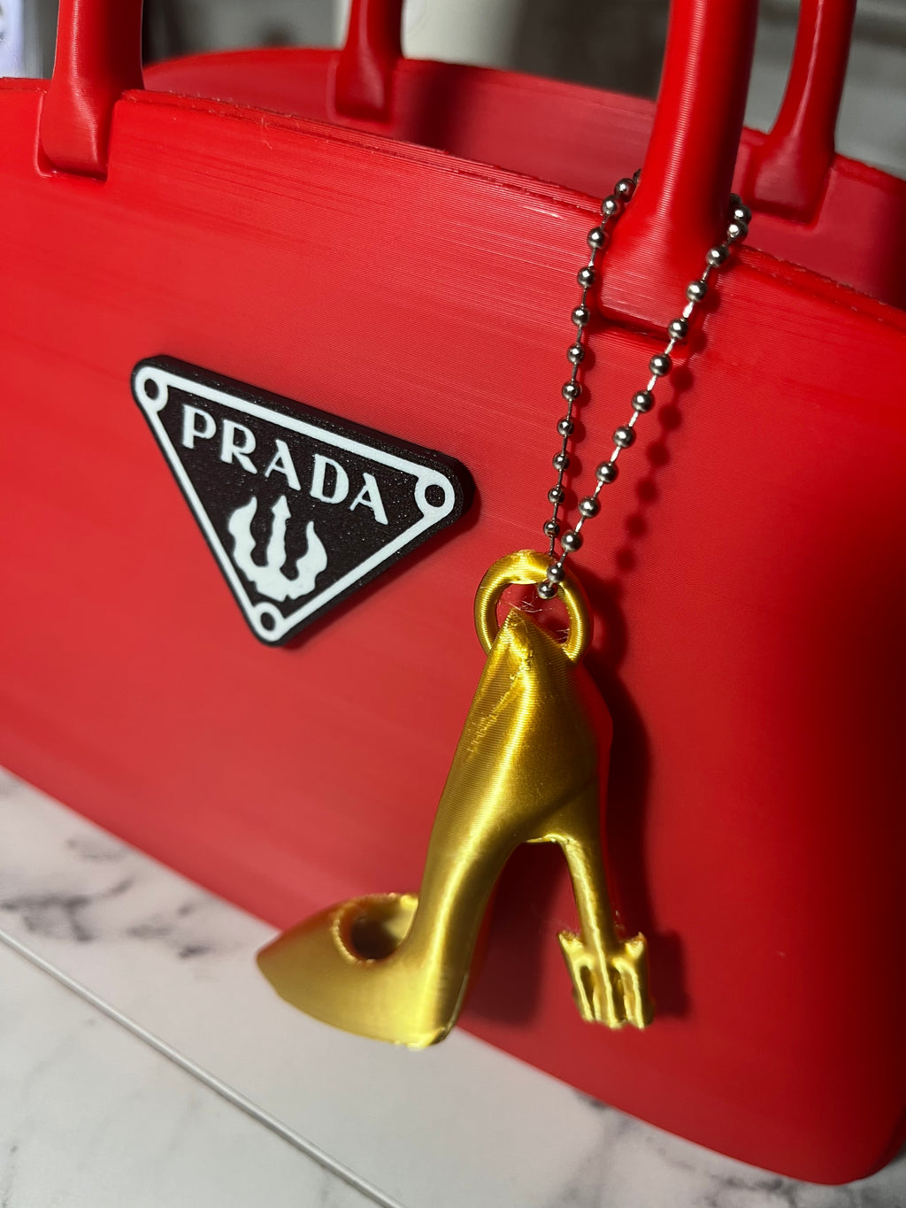 Prada-Inspired Red Handbag Decor with Gold Heel Charm